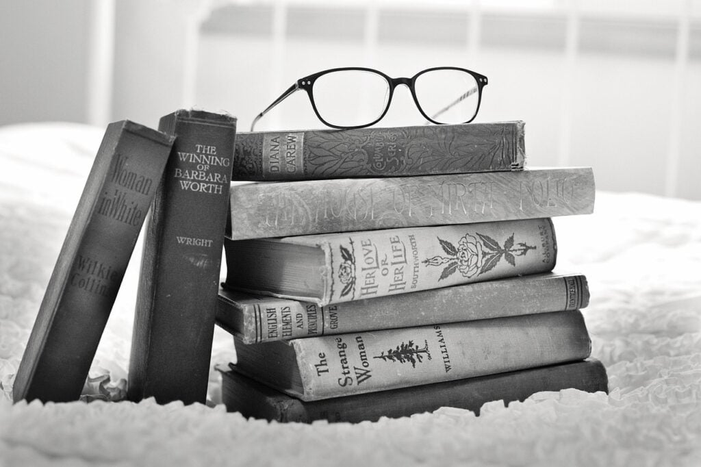 curriculum hopping - stack of books representing different homeschool curricula