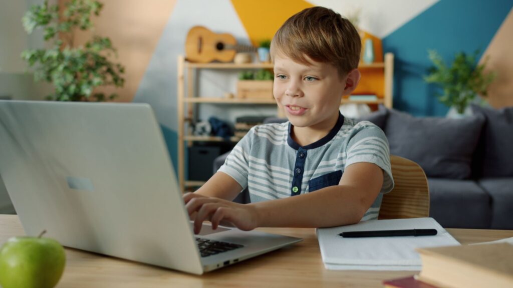 Student working at a laptop in a live online classical class